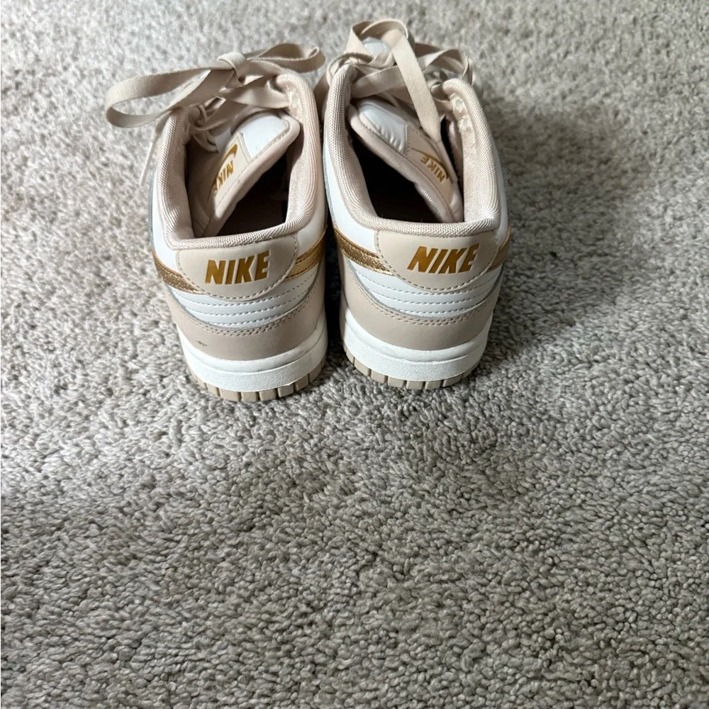 Nike dunks low gold swoosh